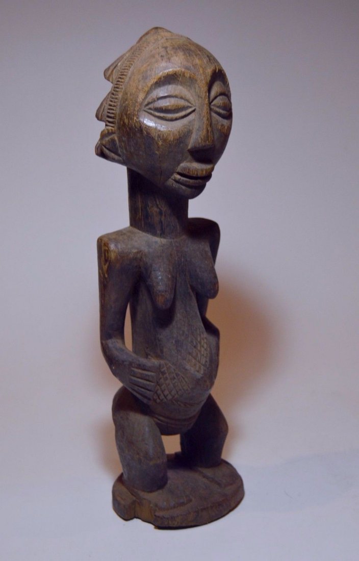 Vintage Hemba female sculpture, African Tribal Art: This is a very fine vintage wood sculpture from the Hemba of the Congo, Central Africa. Carved from a single piece of wood with an undeniable well worn smooth honey colored patina from handling over m