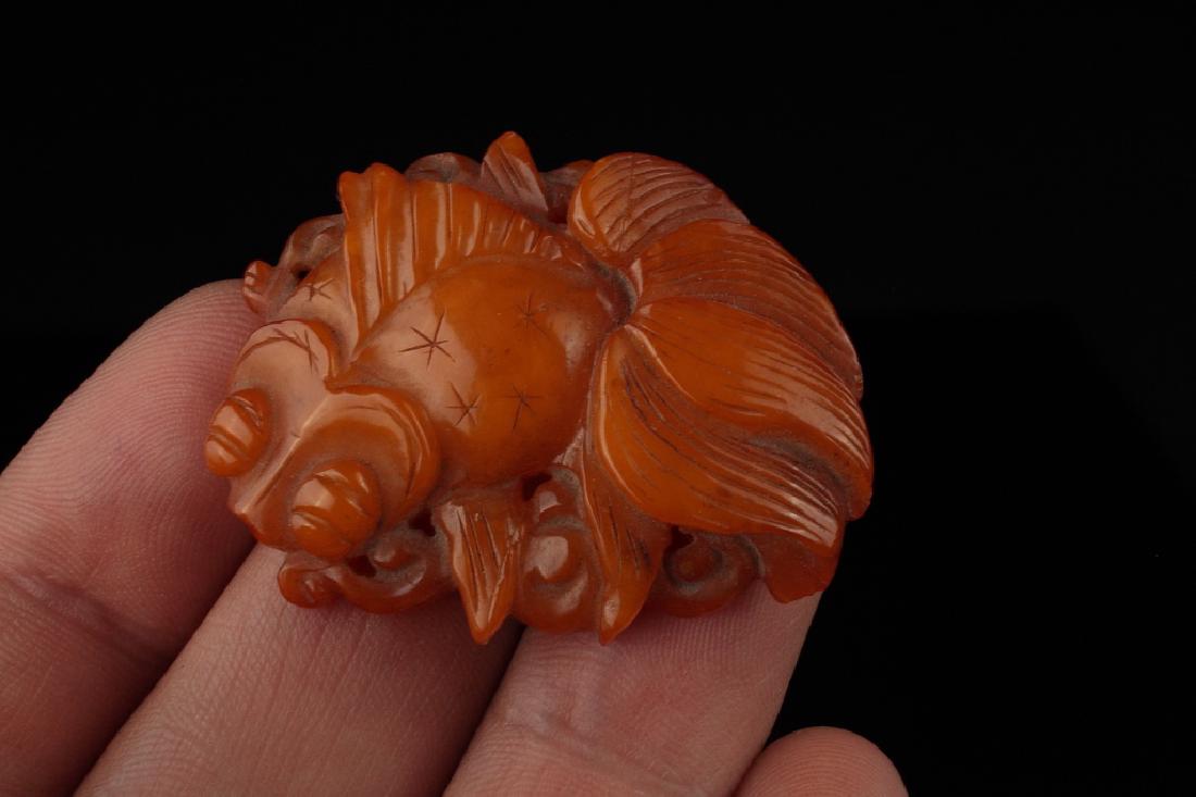 A Chinese Butterscotch Amber Fish Plaque,: Age: Qing dynasty 19th Century Description: A scarce and attractive Chinese butterscotch amber fish shaped plaque. Well carved with fine details as a goldfish (carp) possibly for use as a clothing orn