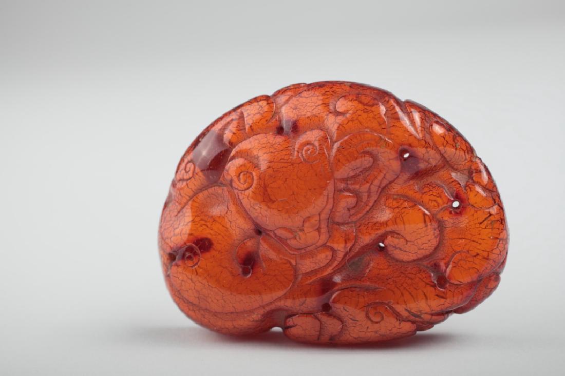 A Chinese chilong carved amber plaque, (1 of 10)