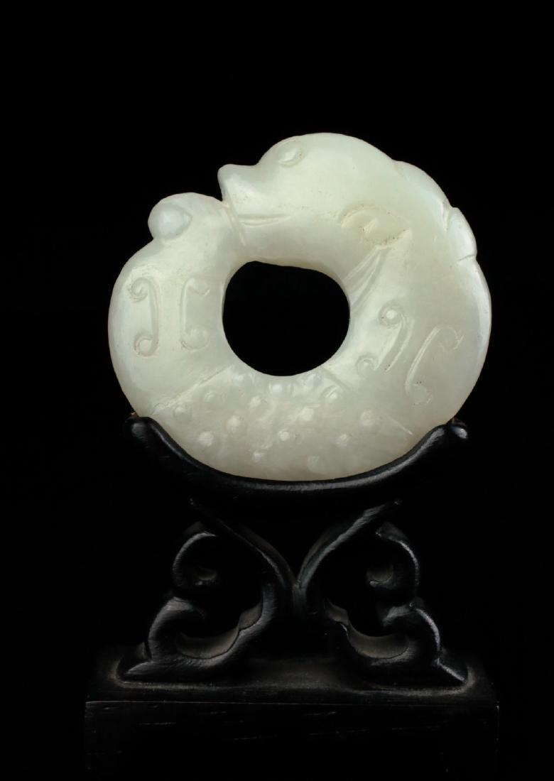 A white jade 'C' dragon pendant, Ming dynasty, (1 of 4)