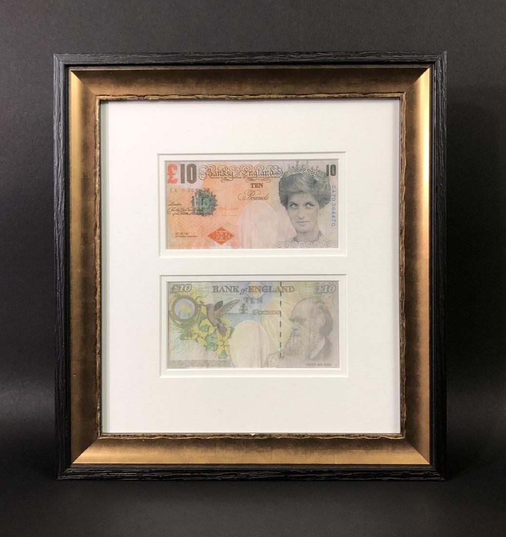 Banksy (British, 1974- ) -- Two Di-Faced Tenners: This lot consists of two fine art prints in vertical order, framed under two-sided glass and attributed to Banksy (British, 1974 - ). Piece includes two ten-pound "Banksy of England" notes bearing the