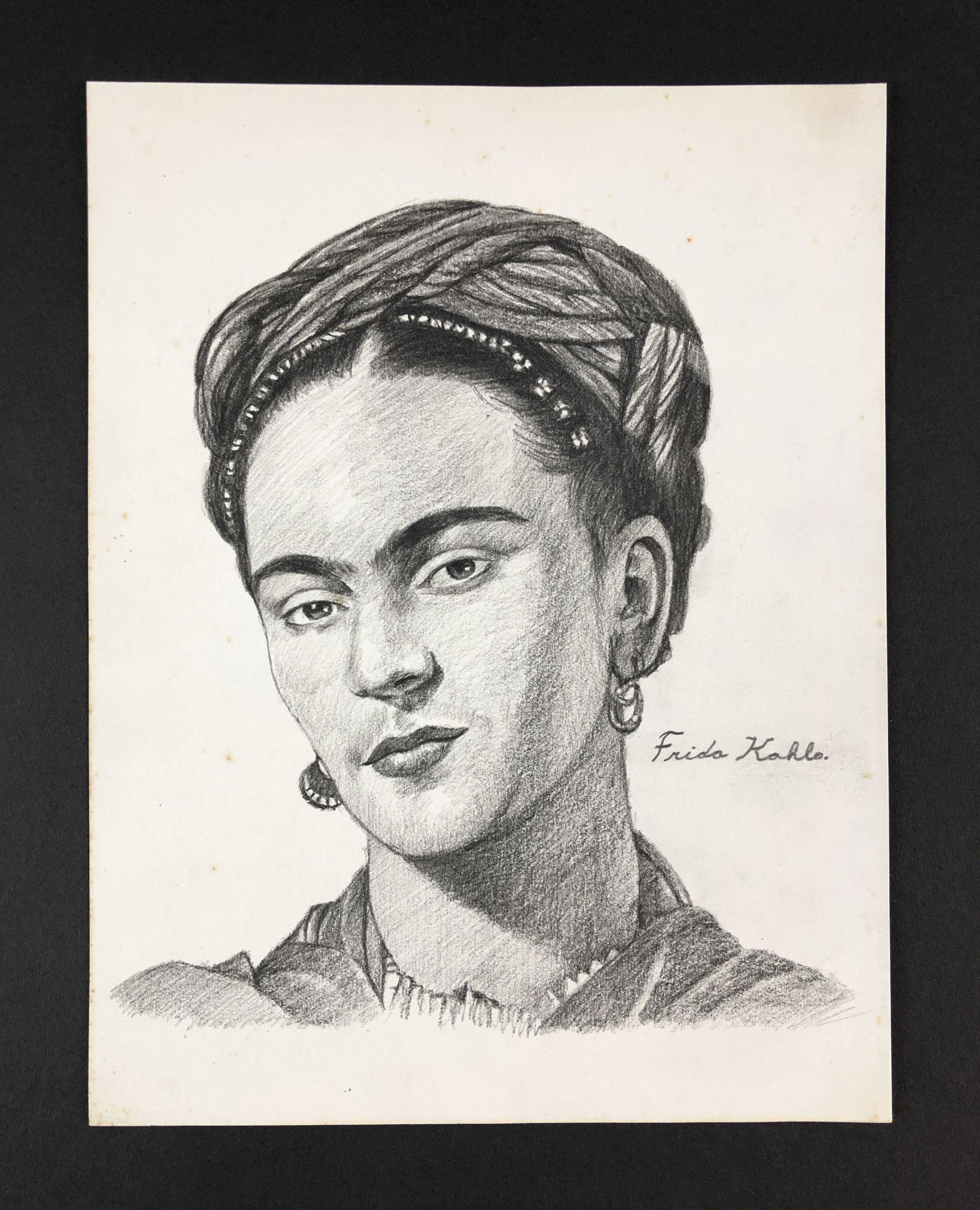 Frida Kahlo (1907-1954) - Graphite on Paper: This lot consists of a graphite illustration on paper, done in the modern style of Frida Kahlo (Mexican, 1907-1954). "Frida Kahlo" is hand written at right of painting. This beautifully detailed image