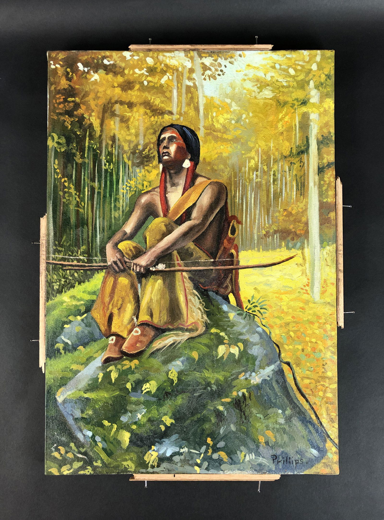 Bert Geer Phillips (1868 - 1956) - Acrylic on Canvas: This lot consists of an unframed acrylic painting on stretched canvas, done in the naturalist landscape style of Bert Geer Phillips (American, 1868 - 1956). Image depicts a young indigenous man sittin