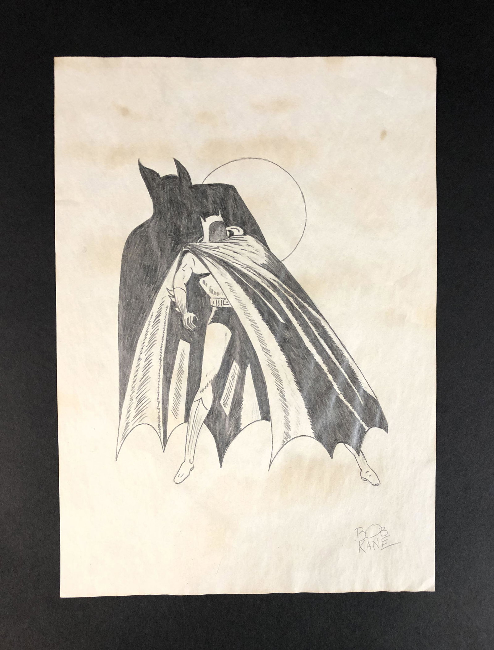 Bob Kane (American, 1915-1998) - Graphite on Paper: This lot consists of a graphite illustration on paper, done in the distinctive cartoon style of Bob Kane (American, 1915-1998). "BOB KANE" is hand written at lower right. Image depicts Batman, an orig