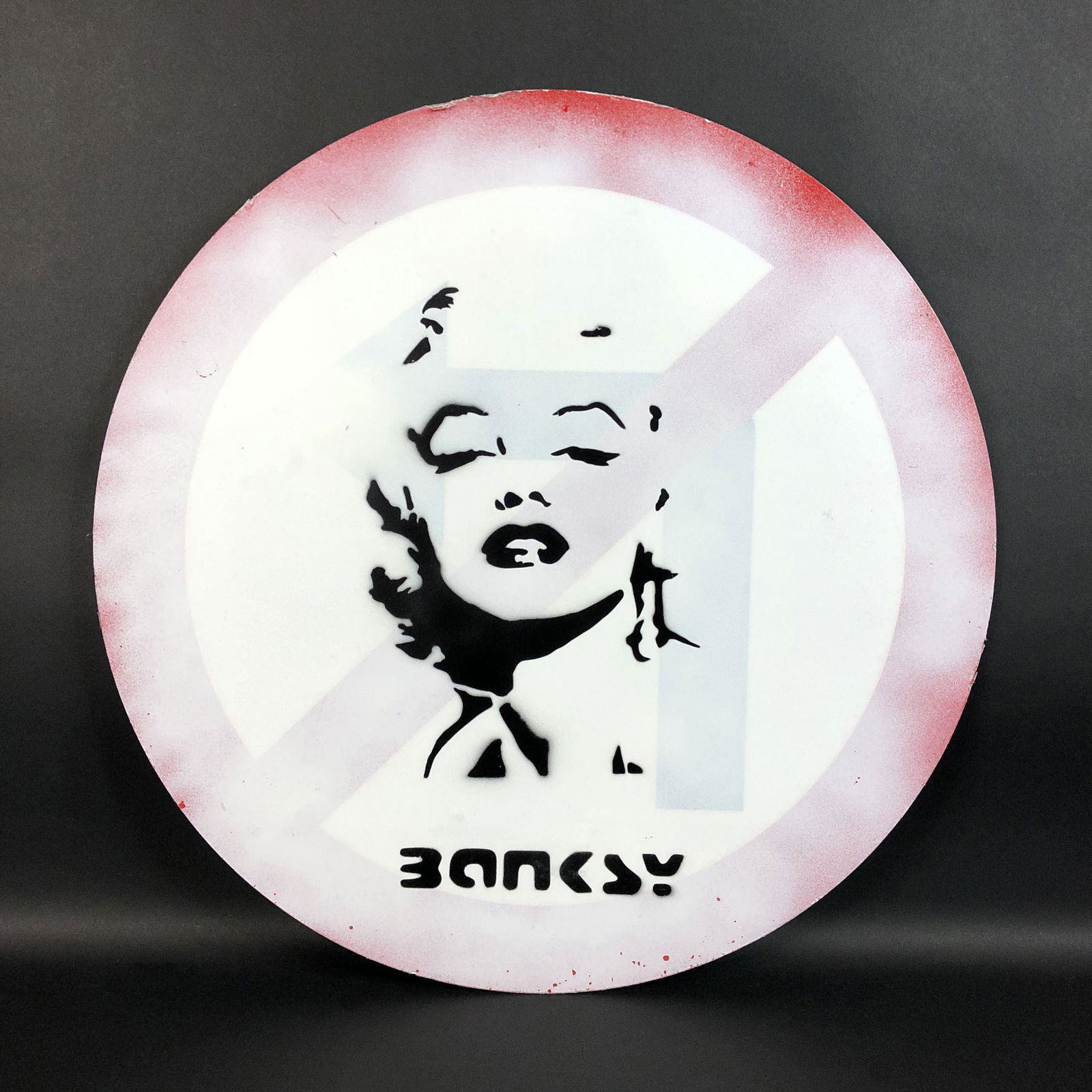 Banksy (British, 1974-) - Aerosol Stencil on Metal: This lot consists of an aerosol painting on a repurposed street sign, done in the contemporary style of street artist Banksy (British, 1974 -). Image depicts the American film star and sex icon, Maril