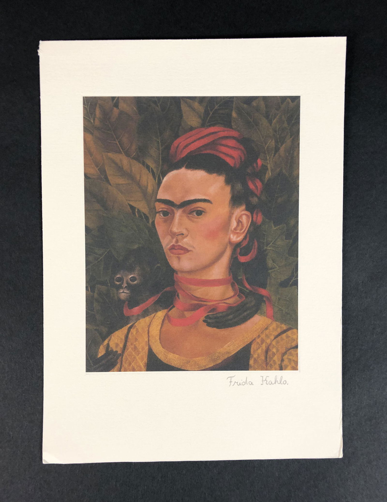 Frida Kahlo (Mexican, 1907-1954) - Fine Art Print: This lot consists of an unframed print on paper, done in the modern style of Frida Kahlo (Mexican, 1907-1954). "Frida Kahlo" There's a handwritten inscription in graphite at lower right corner. This b