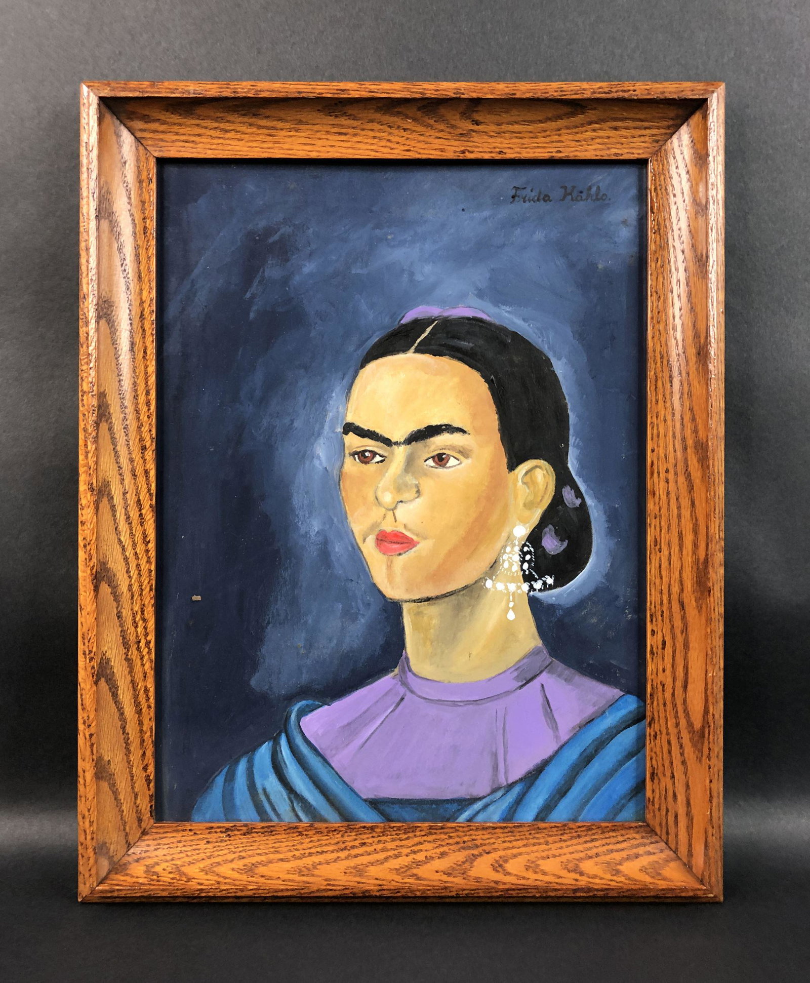 Frida Kahlo - Watercolor on Paper (style of): This lot consists of a watercolor illustration on paper, framed under glass, done in the modern style of Frida Kahlo (Mexican, 1907-1954). "Frida Kahlo" is hand painted at top right. This beautifully 