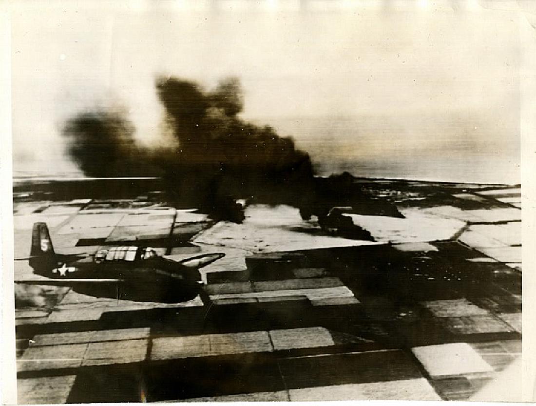 W. EUGENE SMITH, Bomb damage and American torpedo: W. EUGENE SMITH, Bomb damage and American torbedo bomber, Mariana Islands. The photograph was taken from another plane. The attached snipe reads "Yanks over Marianas. First photo showing smoke pillars