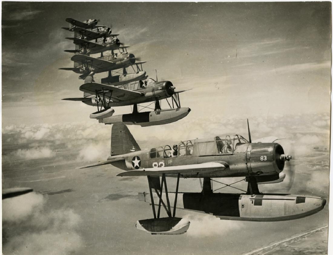 W. Eugene Smith, Formation of Kingfisher airplanes.: W. Eugene Smith, Formation of Kingfisher airplanes. 7 ½ x 9 ½- inch gelatin silver print, 1940's. "Kingfisher I" in pen verso. Smith's Black Star credit stamp and London Black Star stamp on the vers