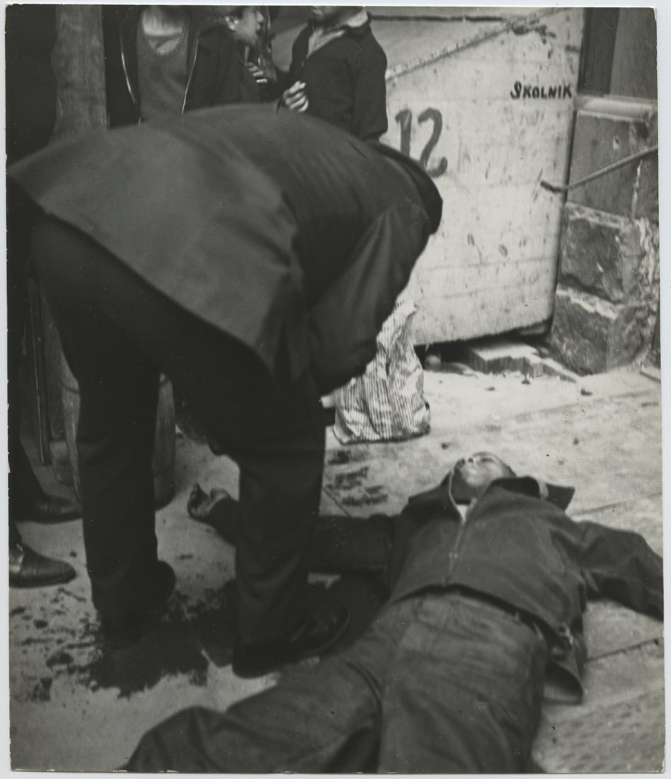 John Gutmann. Harlem street scene: John Gutmann, Harlem street scene. Vintage ferrotoyped gelatin silver print on single weight paper with this snipe—“Certain Harlem corner[s] are known as dangerous murderous corners and stay away