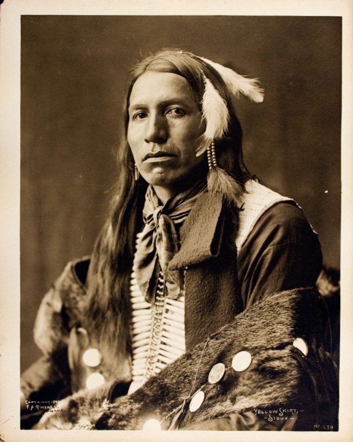 YELLOW SHIRT (Ogle Zizi), Oglala Lakota, 1899.: YELLOW SHIRT (Ogle Zizi), Oglala Lakota, 1899. Unmounted 9 ¼ x 7 3/8 platinotype. “Copyright 1899 / F.A. Rinehart, / Omaha.-Yellow Shirt,- / -Sioux- No1539” [in neg] A beaded vest and hairpipe br