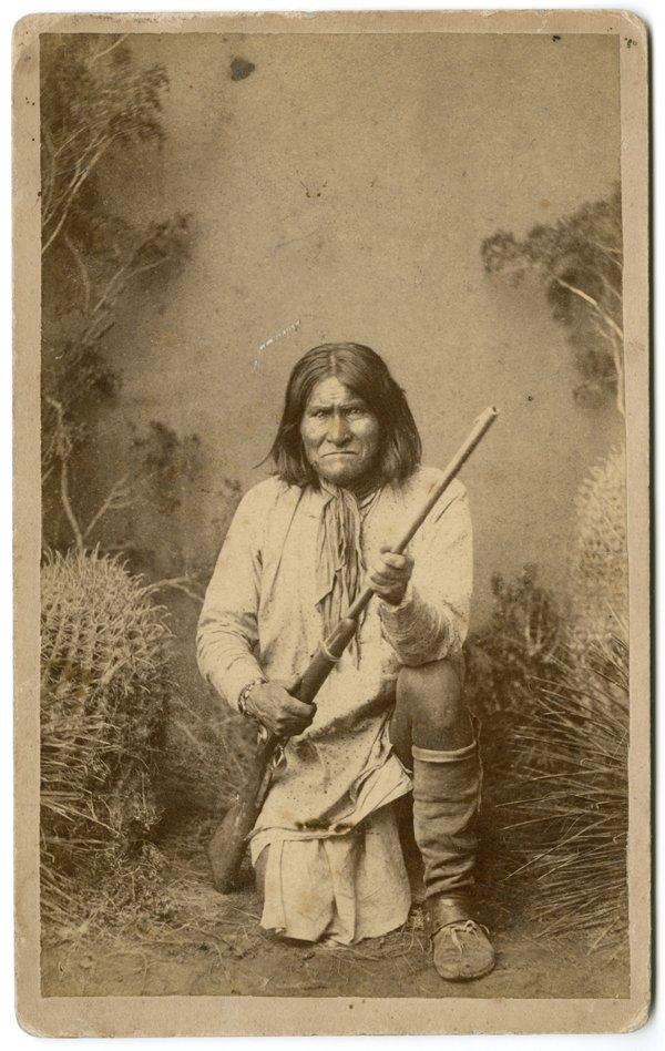 GERONIMO KNEELING WITH HIS RIFLE.: GERONIMO KNEELING WITH HIS RIFLE. This is an albumen print on a boudoir mount of this famous photograph by A. Frank Randall. It has Randall’s copyright label on the verso, over-stamped in red “Cop