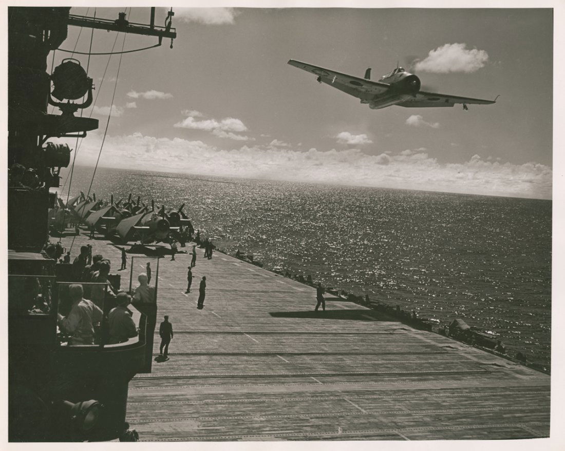 USS BUNKERHIILL, 1943 BY W. EUGENE SMITH.: USS BUNKERHIILL, 1943 BY W. EUGENE SMITH. 11 x 13 7/8-inch gelatin silver print. Has Smith’s familiar circular credit stamp from the estate, but also a stamp in a rectangle that indicates that this