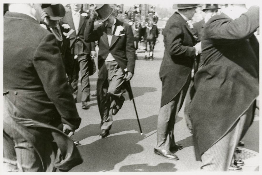 HOBOKEN NEW JERSEY PARADE, by ROBERT FRANK: HOBOKEN NEW JERSEY PARADE, by ROBERT FRANK. 11 x 13 7/8- inch gelatin silver print, 1955. "R B" in pencil on verso. There are two celebrated photographs by Frank that deal with this event. Both show