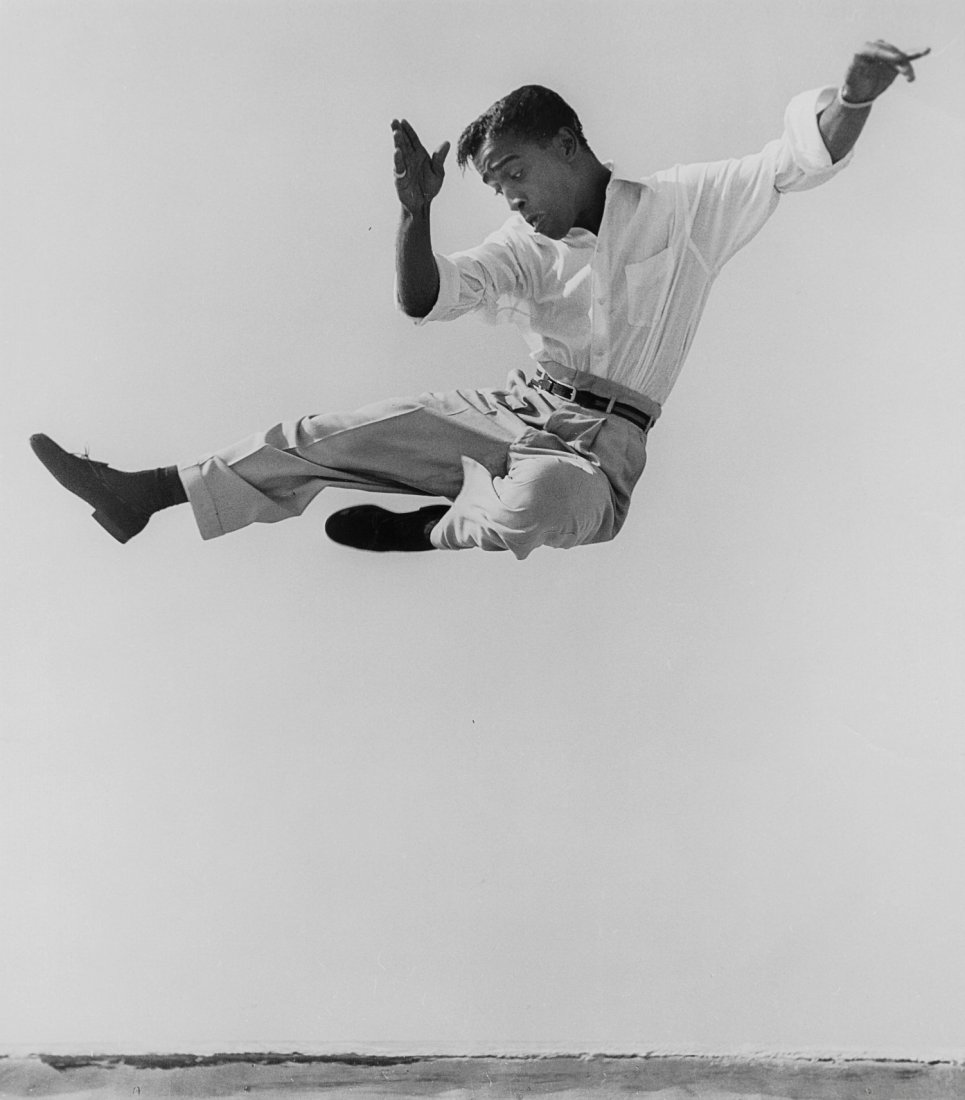 SAMMY DAVIS, JR. UP IN THE AIR: SAMMY DAVIS, JR. UP IN THE AIR. 14 x 11 gelatin silver print, 11 ½ x 10 image area, by Phil Stern. Signed by Stern and dated 1947, with "Vintage print!" and his credit stamp and copyright stamp on ve