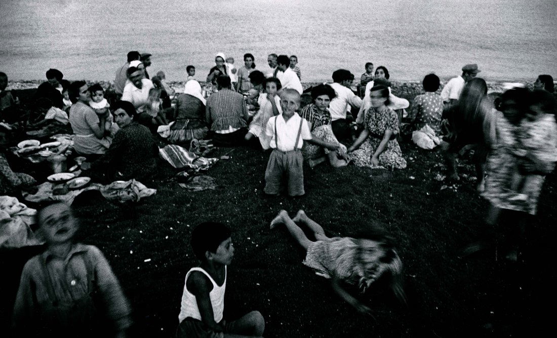 PICNIC ST. TORIN 1956 BY WILLIAM KLEIN.: "PICNIC ST. TORIN 1956" BY WILLIAM KLEIN. 10 1/2 x 17 3/8- inch image on 16 x 20- inch paper, signed and dated 1980 on verso. This is on the Greek island of Torini.