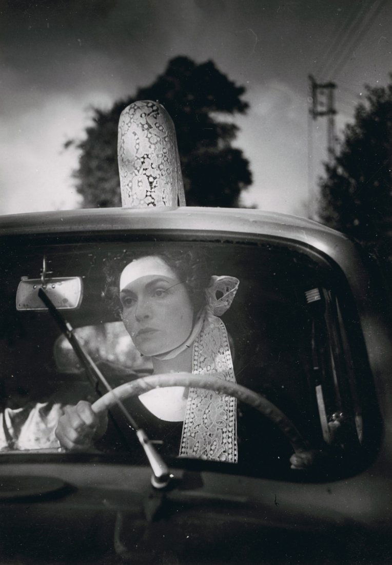 GILBERTE BRASSAI WITH COIFFE BY BRASSAI.: GILBERTE BRASSAI WITH COIFFE BY BRASSAI. 8 3/8 x 4 3/8 – inch gelatin silver print, ferrotyped, 1953. Brassai's copyright stamp on verso, with pencil dedication by Gilberte and pencil notation. Bras