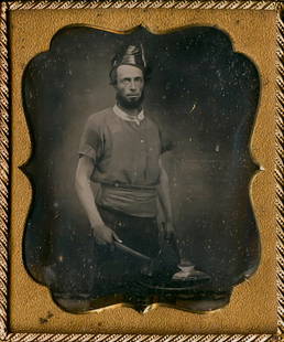 BLACKSMITH AT HIS FORGE WITH HIS TOOLS, 1/6 PLATE: BLACKSMITH AT HIS FORGE WITH HIS TOOLS, 1/6 PLATE DAGUERREOTYPE. With sleeves rolled up, he's in his work clothes with apron, leather hat. The metal has just been taken from the furnace. It glows. Ear