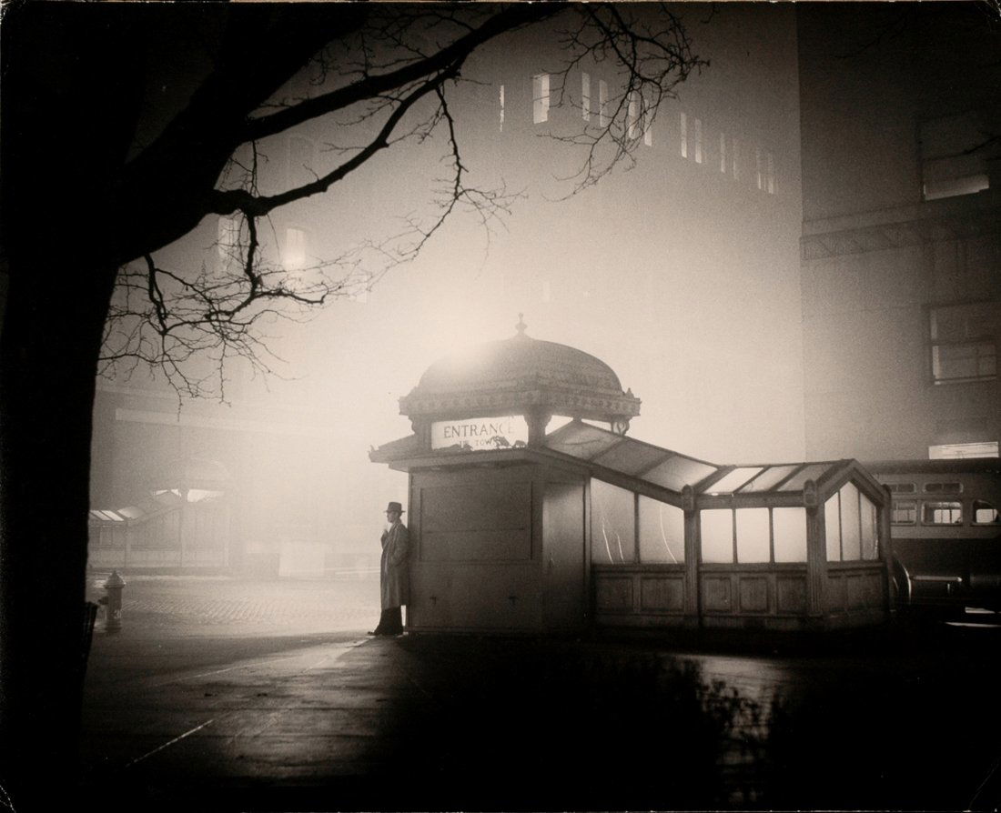 WELLINGTON LEE, "SUBWAY ENTRANCE" FILM NOIR FEELING: WELLINGTON LEE, "SUBWAY ENTRANCE", 1956 (or before.) 14 x 17- inch gelatin silver print, unmounted. Title in pencil in Lee's hand, "#4" and other notations in pencil, Lee's 44 Mulberry Street NY stamp