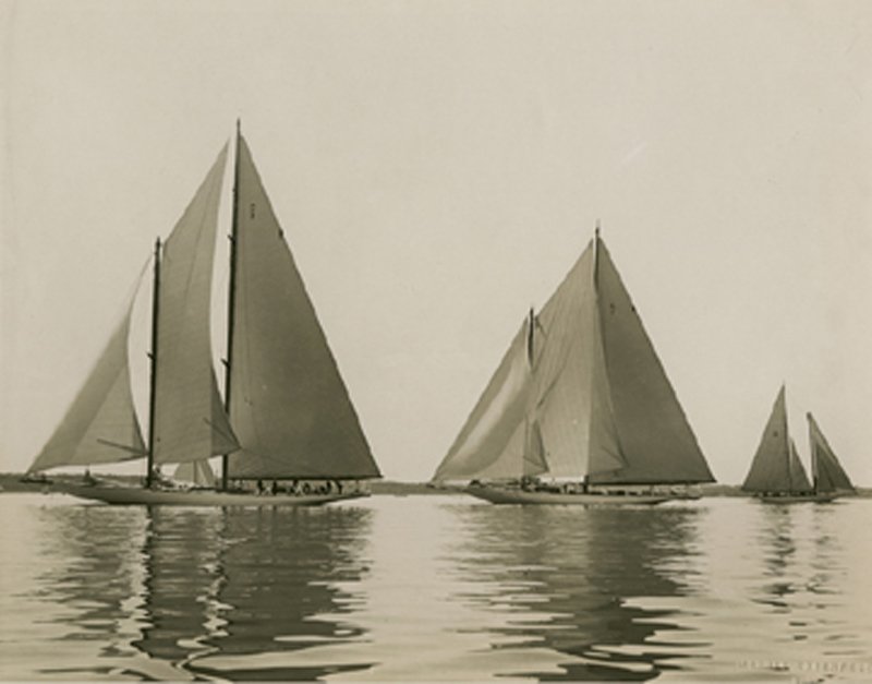 MORRIS ROSENFELD, YACHTS RESOLUTE & VANITIE, 1920: 7 7/8 x 10 1/8- inch toned glossy gelatin silver print, 1920, with Rosenfeld’s embossed blindstamp. Rosenfeld (1885 – 1968) was the major photographer of yachting in New York and New England. The 