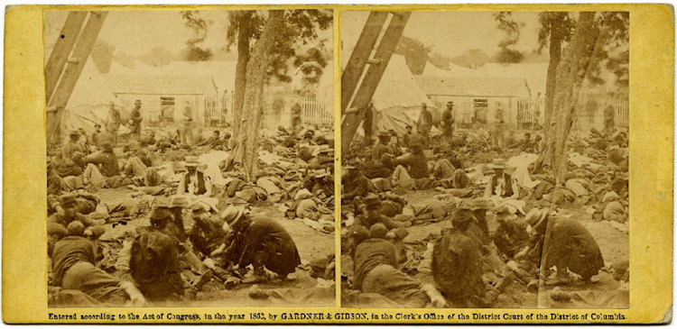 “Wounded, at Savage Station, after the Battle of 27th: “Wounded, at Savage Station, after the Battle of 27th June, ’62.” View No. 491, 1862. Copyright by Gardner and Gibson. The label credits James F. Gibson. In the foreground a wounded soldier’s 