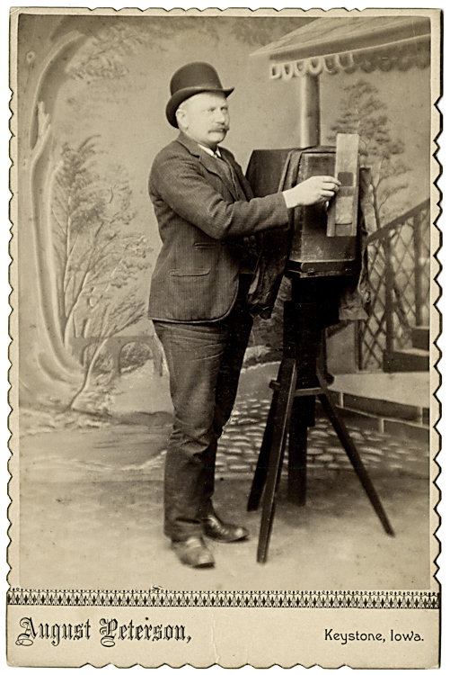 A photographer holds a masking plate or external: A photographer holds a masking plate or external shutter. By August Peterson, Keystone, Iowa.