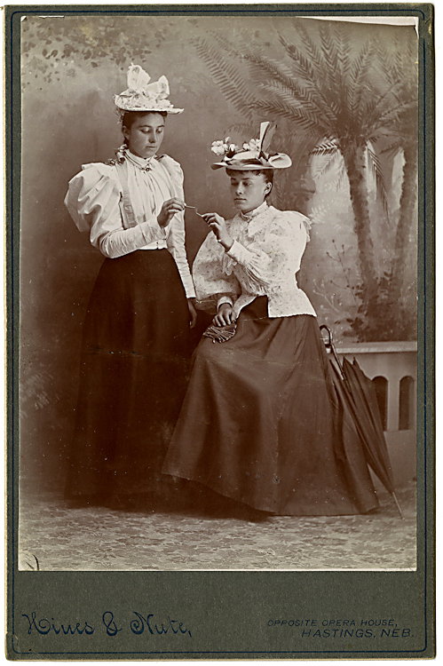 Lighting her cigarette.: Lighting her cigarette. These look like very bourgeois ladies, not bohemians, at a time when it was still daring for women to smoke. By Hines and Nute, Hastings, Nebraska.