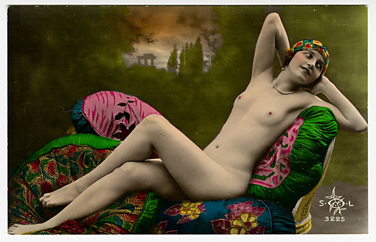 Two colored photo postcards of nudes.: Two colored photo postcards of nudes. a) A seated nude. The highlights on the lacy hanging behind her have been raised, so they glisten. By AN, No. “532.” b) A nude reclines on a divan, with a cla
