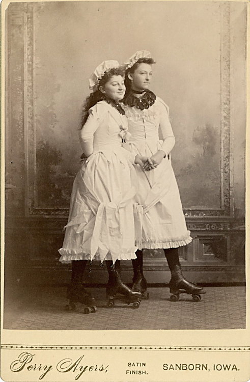 Roller skating women, holding hands, in their roller: Roller skating women, holding hands, in their roller skating dress. Cabinet card by Perry Ayers, Sanborn, Iowa. Clean