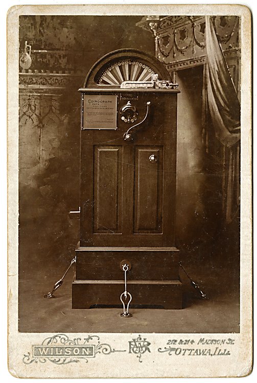 An early slot machine, the “Coinograph.”: An early slot machine, the “Coinograph.” It’s set up in the studio, bolted to the floor. Cabinet card by Wilson, Ottowa, Illinois. The verso is an advertisement by manufacturer, T. J. Nertney of