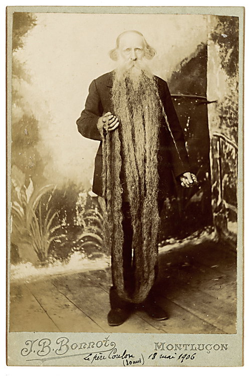 A man with a very long beard.: A man with a very long beard. Cabinet card by Bonnot, Montlucon. The subject has signed on the bottom of the mount “Le pére Coulon (80 ans) 18 mai 1906.” His beard is so long that he has to hold 