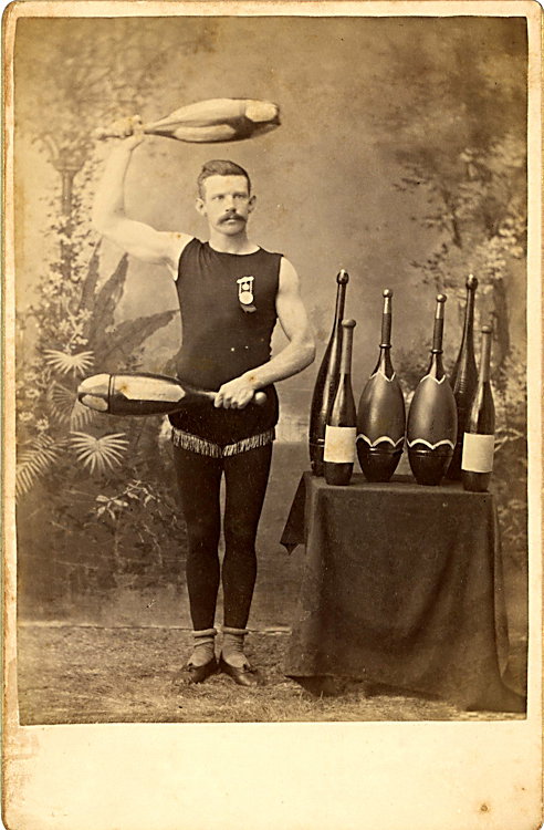 A juggler with clubs and bottles.: A juggler with clubs and bottles. He has a medal. By Miller & Smjith, Dedham, Mass.
