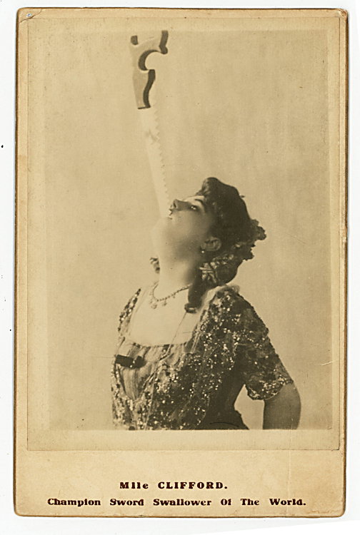 Mlle Clifford “Champion Sword Swallower of the World.”: Mlle Clifford “Champion Sword Swallower of the World.” A saw is entering her mouth, courtesy of a photographic trick illusion. She has endorsed the verso in pencil, from London. No maker indicated