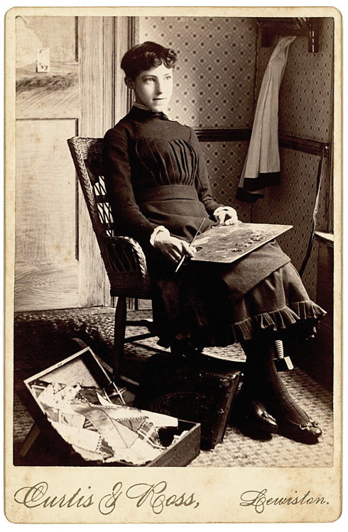 A woman painter with an easel on her lap, scraps of: A woman painter with an easel on her lap, scraps of material on the box on the floor. This is taken in her room, not in the studio. A wonderful portrait and composition. By Curtis & Ross, Lewiston, Ma