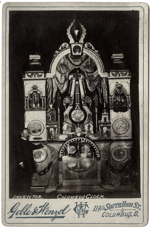Inventor of the Columbus Clock.: Inventor of the Columbus Clock. He stands beside it. A period pen inscription verso says this was 18 feet tall, 11 feet wide, and it was exhibited at the Iowa State Fair in 1891. By Goble & Wenzel, Co
