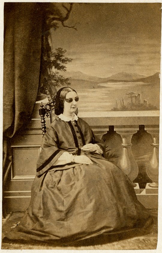 A blind woman is posed before a backdrop that reveals a: A blind woman is posed before a backdrop that reveals a lovely scene she can’t see. Carte de Visite by James Russell, Chichester.
