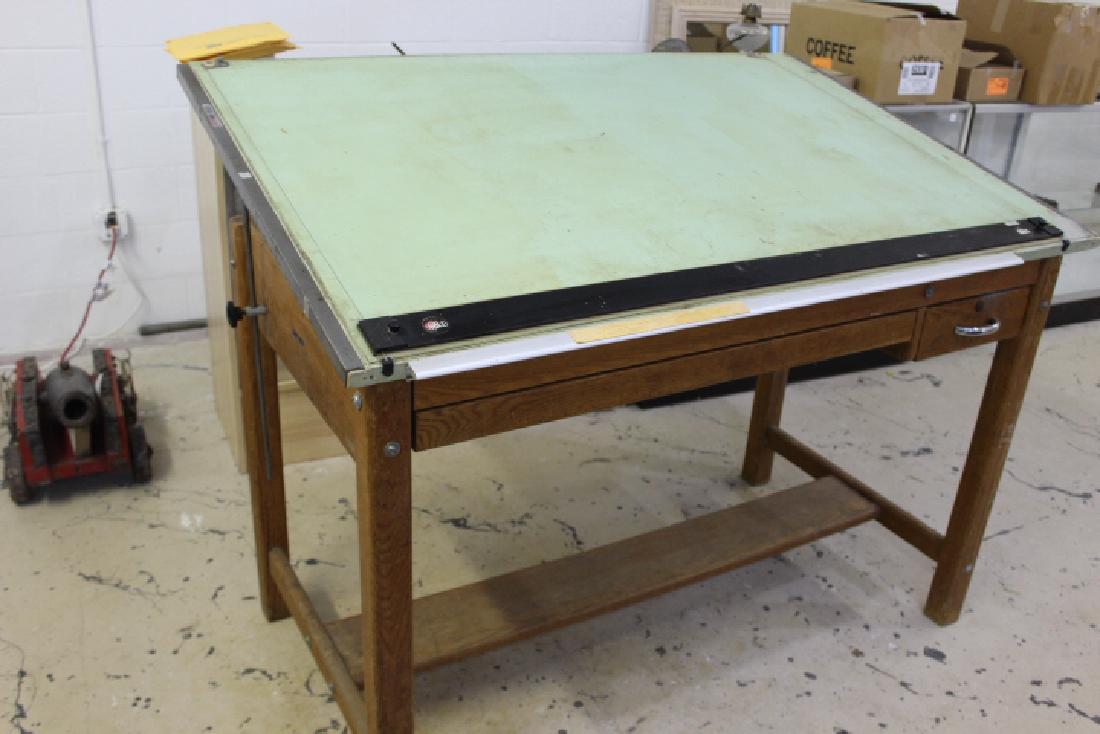 Vintage Mayline Oak Four Post Drafting Table with Green: has large center plan drawer, & tool drawer. About 37 inches tall (when flat) 60 inches wide and 37 1/2 inches