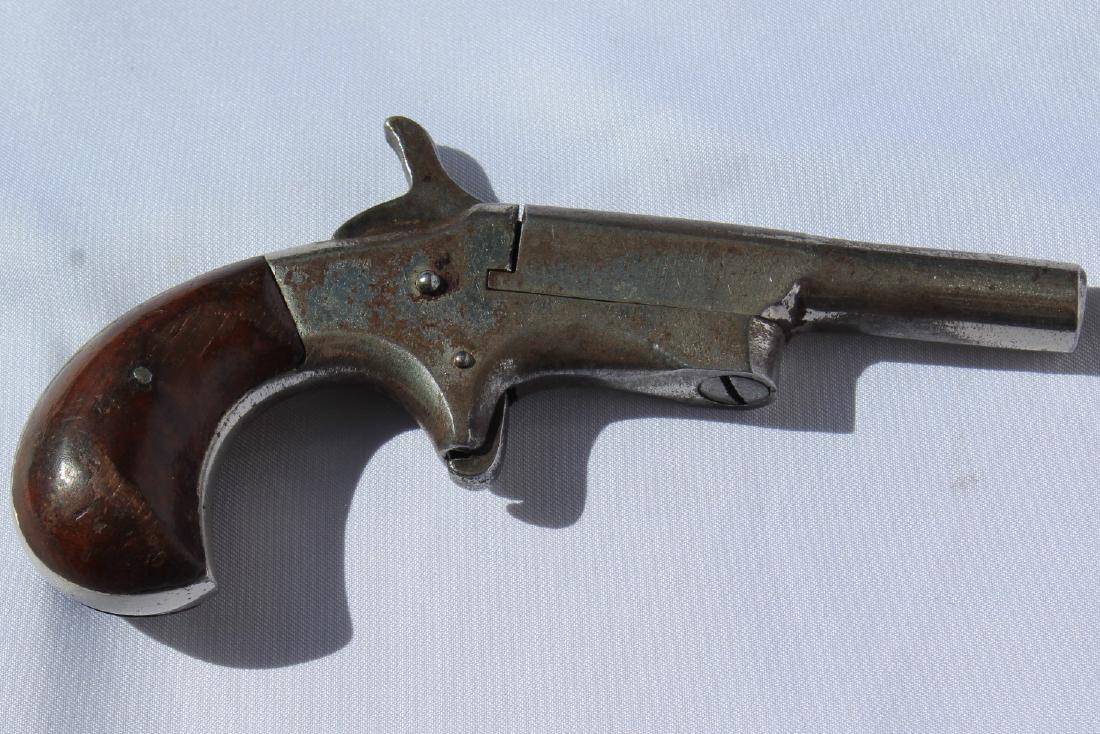 Old Garter Gun with Wood Handle: Garter Gun, a unique piece of history! .22 short manufactured in late 1800â€™s to early 1900â€™s. Single shot with horizontal barrel