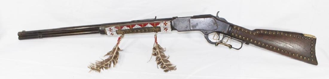 Unique Winchester Model 1873 Repeating Rifle: 23 3/4 inches barrel; manufactured in 1892 - Serial #431774, bought from an Apache Indian - decorated with beadwork, leather, feathers and bone as pictured; stock is studded