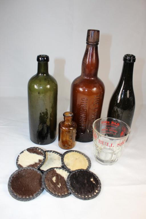 Lot of Old Bottles, Seagrams Bottle Top, etc.: The I Trager Co Cincinnati; texas bull shot glass, Hunyadi Janos Bottle, 4" lysol embossed bottle, plus cow coasters as pictured