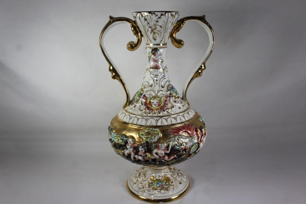 CAPODIMONTE BERNINI VINTAGE CHERUB ITALIAN VASE: Signed Capodimonte Vase. Small chip in Gold at base of Vase, As Pictured. Measures approx. 13 by 8 inches. AS Pictured.