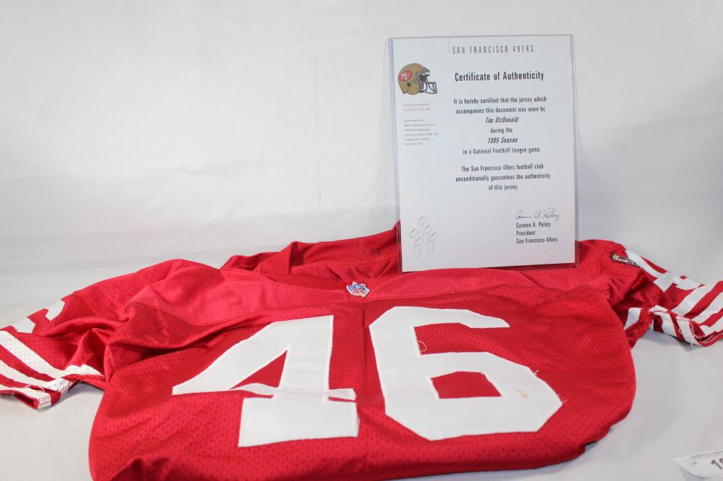 1995 49ERS JERSEY #46 TIM McDONALD W/ COA: #46 TIM McDONALD'S JERSEY DURING THE 1995 SEASON. INCLUDES COA BY CARMEN A. POLICY. UNKNOWN IF COA IS AUTHENTIC, USE YOUR OWN JUDGEMENT. HAS HOLE IN FRONT AND SOME THREADS HANGING, AS WELL AS STAINING