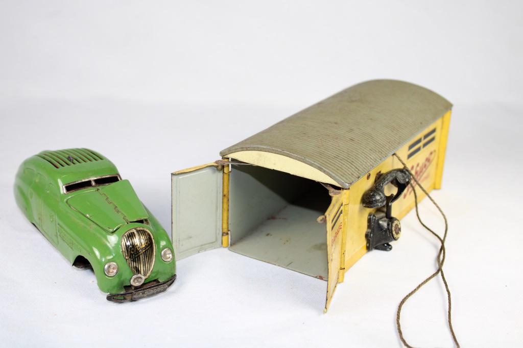 Schuco Garage Tin Toy with Car: Garage with phone lever to open doors, with green schuco car (missing the front wheels)