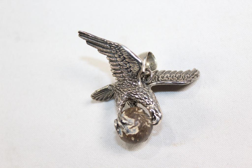 STERLING SILVER EAGLE PENDANT HOLDING MUSKET BALL: CIVIL WAR ERA OR REVOLUTIONARY WAR ERA MUSKET BALL GRIPPED BY FLYING EAGLE STAMPED AK 925 PENDANT. TOTAL WEIGHT: 1.1 OZ INCLUDING MUSKET BALL. AS PICTURED