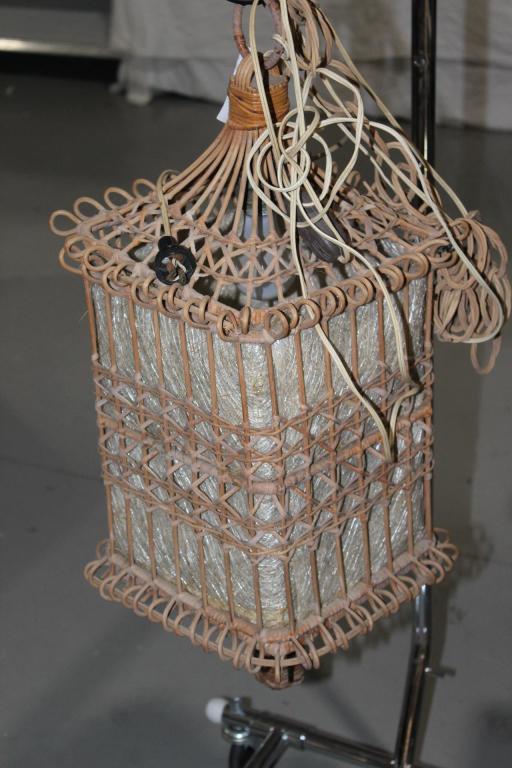 HANGING WICKER LANTERN/LAMP&SHADE- ELECTRIC: MEASURES APPROX. 30 BY 12 BY 12 INCHES. TESTED & WORKS- HAS ON OFF SWITCH ON CORD. AS PICTURED