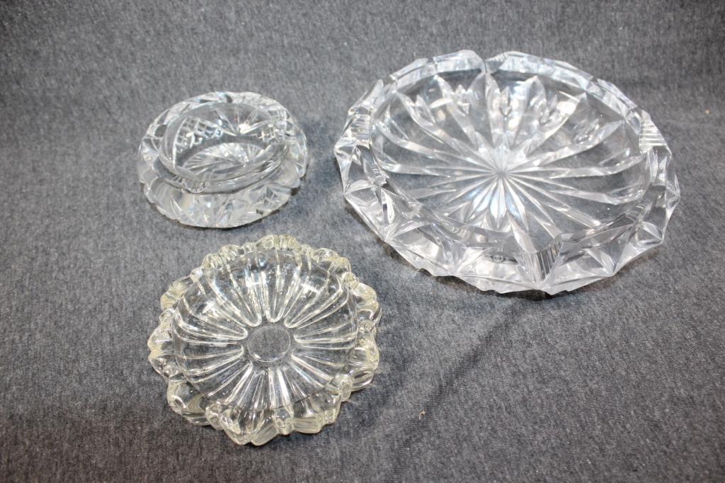 3 PC. GLASS?/CRYSTAL? CUT ASHTRAYS LOT: LARGEST MEASURES APPROX. 2 BY 8 INCHES. MEDIUM MEASURES APPROX. 1 BY 4.5 INCHES. SMALLEST MEASURES APPROX. 2 BY 4 INCHES. NO VISIBLE DAMAGE ON ANY. AS PICTURED