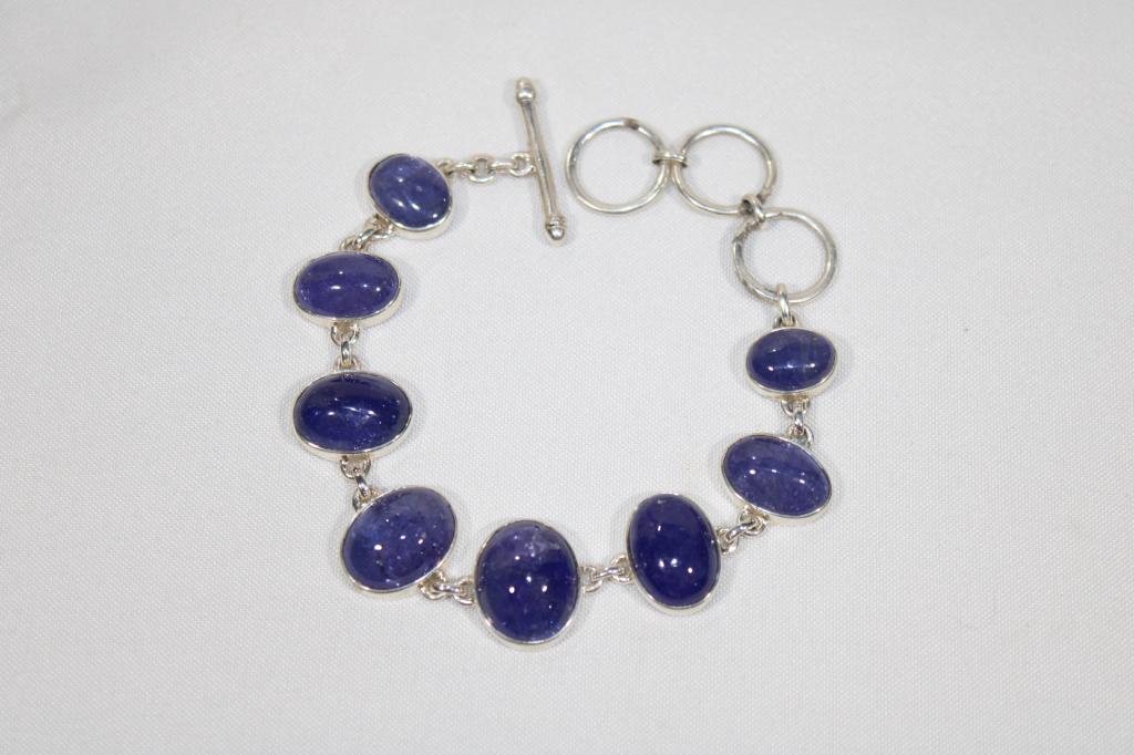 Polished Tanzanite and Sterling Silver Bracelet: measures about 8 1/2 inches long from end to end with toggle end; slight blemish on one stone as pictured