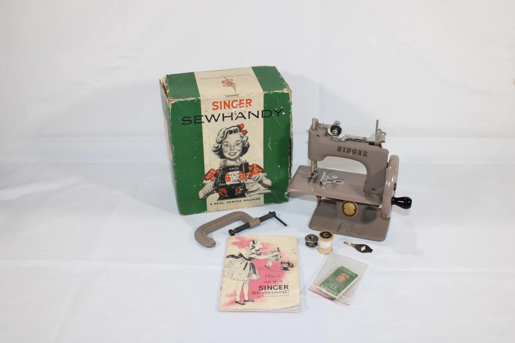 Singer Sewhandy Model 20 in Original Box: Includes Model #20 sewing machine, instructions, clamp, bobbin, needles and original box. Measures 7" wide x 3" deep x 6" tall.