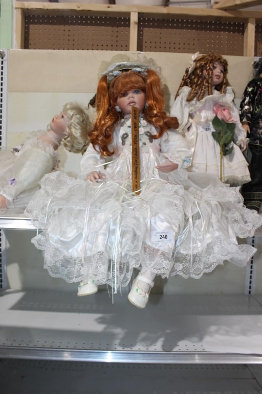 Large porcelain doll sitting on ledge (1 of 1)