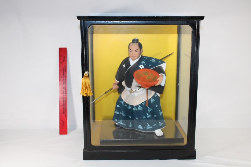 Asian style statue in display case (1 of 3)